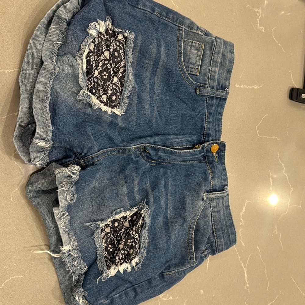 Ripped jean shorts with black lace